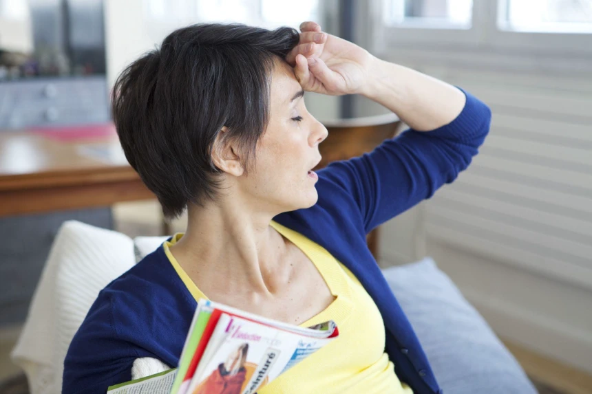 Kobieta zastanawiająca się, jakie są objawy menopauzy
